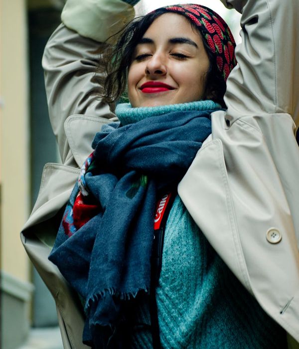 Woman feeling energetic and vibrant in a bright space.